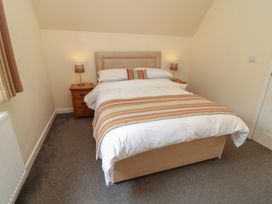 A bedroom with a bed and bedside table at Lodge 13 Brigg