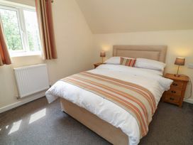 A bedroom with a bed and bedside tables at Lodge 13 in Brigg