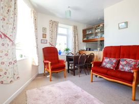 A living room with red furniture and a dining area at Chyancbrowse in Gulval