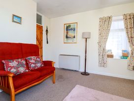 A living room with a red sofa and lamp at Chyancrowse Gulval