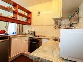 A kitchen with an oven, sink, and microwave at Chyancrowse Gulval