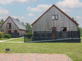 Two wooden houses with ramps and grass area at Lodge 14 in Brigg