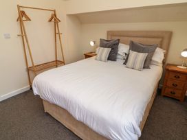 A bedroom with a bed and hanging rack at Lodge 14 in Brigg