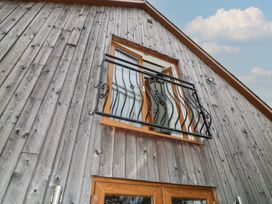 A balcony with a window on a wooden wall at Lodge 14 Brigg