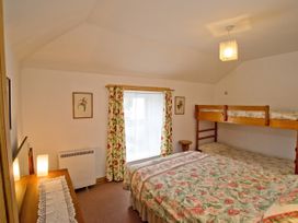 A bedroom with a double bed and bunk bed at Chyandaunce in Gulval