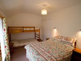 A bedroom with a double bed and a bunk bed at Chyandaunce in Gulval
