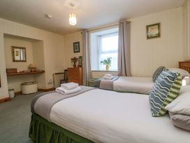 A bedroom with two beds and a desk at Chyandaunce in Gulval