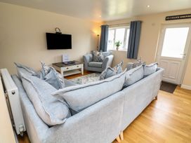A living room with a sofa and armchair at Lodge 21 in Brigg
