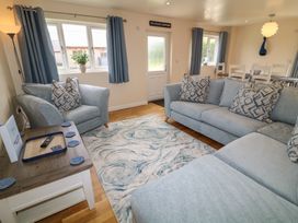 A living room with a sofa and coffee table at Lodge 21 in Brigg