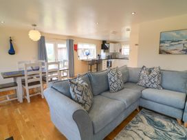 A living room with a sofa and dining area at Lodge 21 in Brigg
