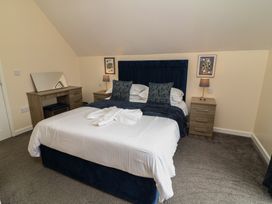 A bedroom with a bed and a desk at Lodge 21 in Brigg