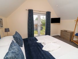 A bedroom with a bed and dresser at Lodge 21 Brigg