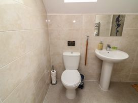 A bathroom with a toilet and sink at Lodge 21 in Brigg