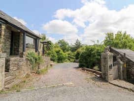 An outdoor view with a stone building and a driveway at The Old Barn in Ciliau Aeron near Aberaeron