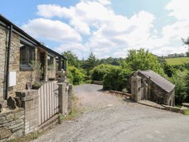 An outdoor area with a stone house and gravel driveway at The Old Barn in Ciliau Aeron near Aberaeron