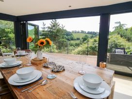 A dining room with a table set for a meal at The Old Barn in Ciliau Aeron near Aberaeron