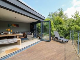 A dining room with a table and sofa at The Old Barn in Ciliau Aeron near Aberaeron