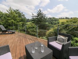 A deck area with chairs and table at The Old Barn in Ciliau Aeron near Aberaeron