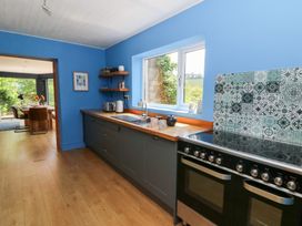 A kitchen with a sink and oven at The Old Barn in Ciliau Aeron near Aberaeron