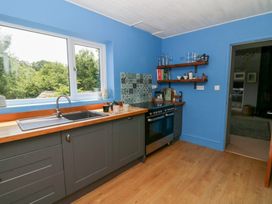 A kitchen with a sink and stove at The Old Barn in Ciliau Aeron near Aberaeron