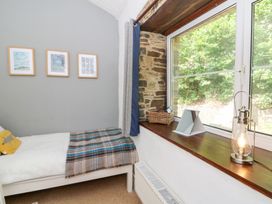 A bedroom with a bed and window at The Old Barn in Ciliau Aeron near Aberaeron