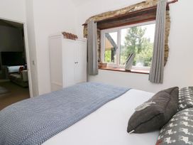 A bedroom with a bed and a window at The Old Barn in Ciliau Aeron near Aberaeron