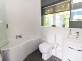 A bathroom with a bathtub and a toilet at The Old Barn in Ciliau Aeron near Aberaeron
