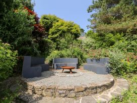 A garden with seating and a fire pit at The Old Barn in Ciliau Aeron near Aberaeron