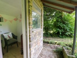 An outdoor area with a chair and plants at The Old Barn in Ciliau Aeron near Aberaeron