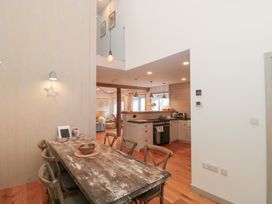 A dining room with a wooden table and chairs at The Threshing Barn in Chipping Norton