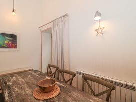 A dining room with a wooden table and a bowl at The Threshing Barn in Chipping Norton
