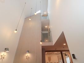 An indoor view with stairs and hanging lights at The Threshing Barn in Chipping Norton