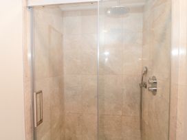 A shower with glass door and fixtures at The Threshing Barn in Chipping Norton