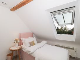 A bedroom with a bed and a window at The Threshing Barn Chipping Norton