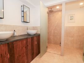 A bathroom with two sinks and a shower at The Threshing Barn Chipping Norton