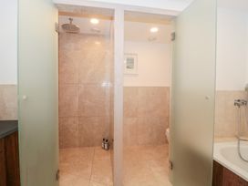 A bathroom with shower and toilet at The Threshing Barn in Chipping Norton