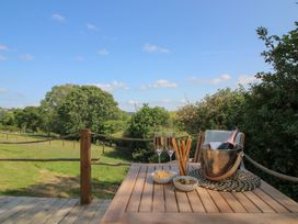 An outdoor area with a table set for drinks and snacks at Squirrel's Drey in Chapel Lawn near Clun