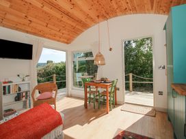 A dining room with a table and chairs at Squirrel's Drey in Chapel Lawn near Clun