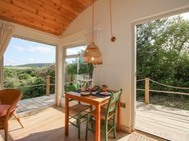 A dining area with a table and chairs at Squirrel's Drey in Chapel Lawn near Clun