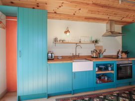 A kitchen with a sink and cooking appliances at Squirrel's Drey Chapel Lawn near Clun