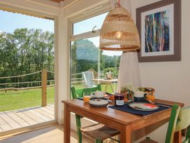 A dining room with a table set for breakfast at Owl's Hollow in Chapel Lawn near Clun