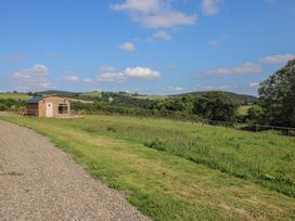 A wooden house on a grassy area at Owl's Hollow Chapel Lawn near Clun