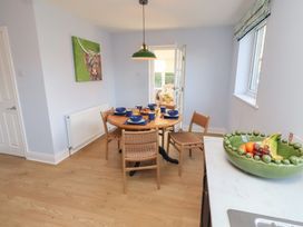 A dining room with a table and chairs at Linn Cottage in Hexham