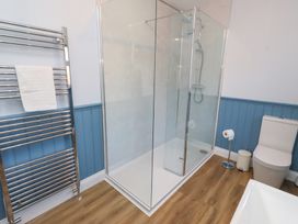 A bathroom with a shower and toilet at Linn Cottage in Hexham