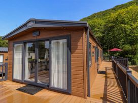 A cabin with sliding doors and a deck at The Beaumont No 34 New Quay