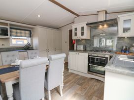 A kitchen with dining area and modern appliances at The Beaumont No 34 in New Quay