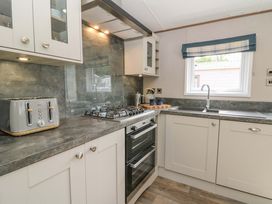 A kitchen with appliances and cabinetry at The Beaumont No 34 New Quay