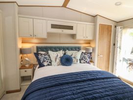 A bedroom with a bed and bedside lamps at The Beaumont No 34 in New Quay