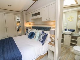 A bedroom with a bed and wardrobe at The Beaumont No 34 New Quay