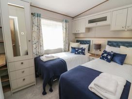 A bedroom with twin beds and wardrobe at The Beaumont No 34 in New Quay